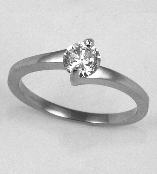 Unedited silver-tone solitaire twist ring with a clear round stone, shot flat against a grey background