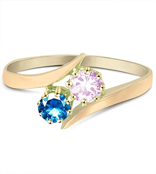 Unedited vintage gold bypass ring with blue and clear round stones, scratched and shot on a grey background